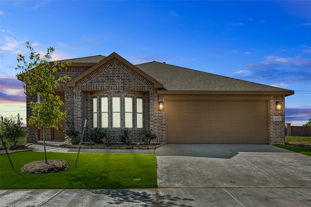 view of front of property with a lawn and a garage