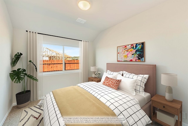 carpeted bedroom featuring lofted ceiling