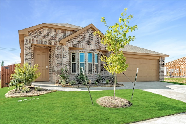 view of front of house with a front yard and a garage