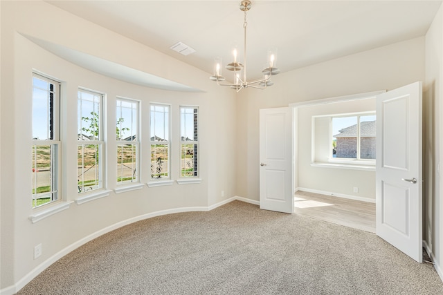 empty room featuring light colored carpet and plenty of natural light