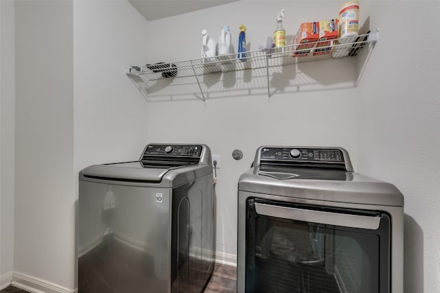 laundry area featuring separate washer and dryer and hardwood / wood-style floors