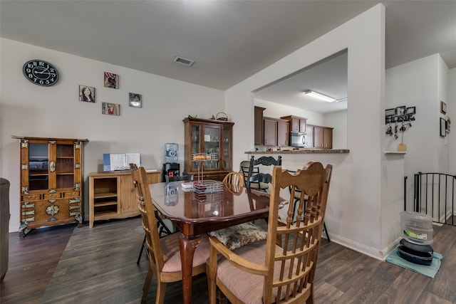 dining room with dark hardwood / wood-style floors