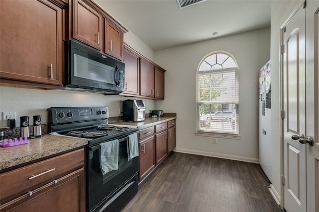 kitchen featuring dark wood-type flooring and black appliances