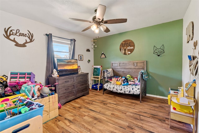 bedroom with light hardwood / wood-style floors and ceiling fan