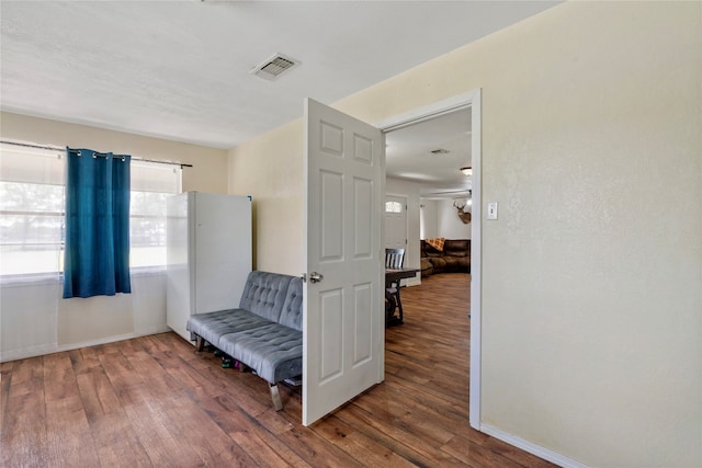 sitting room featuring ceiling fan and dark wood-type flooring