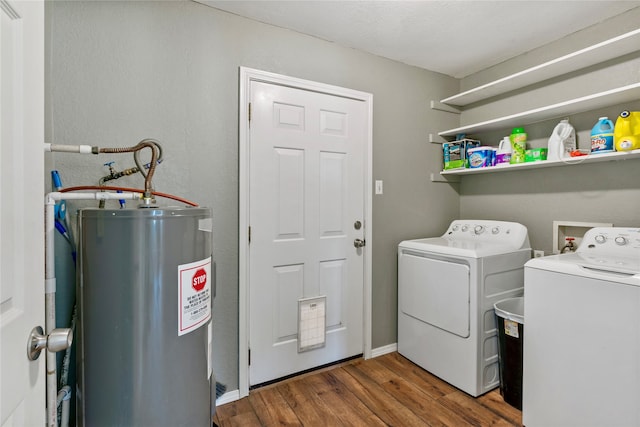 washroom with washer and clothes dryer, water heater, dark hardwood / wood-style floors, and a textured ceiling