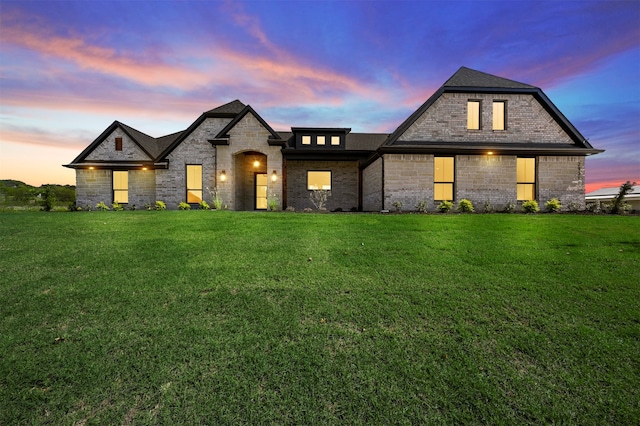 french country style house with a yard