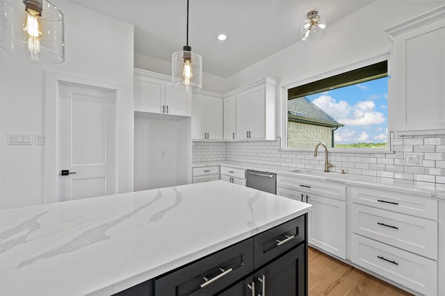 kitchen featuring white cabinets, hanging light fixtures, and sink