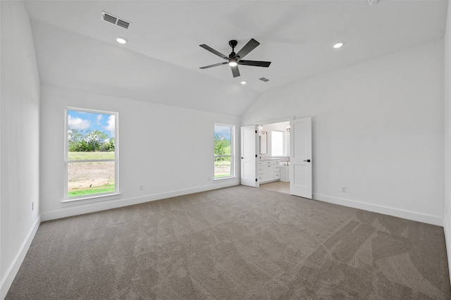 unfurnished bedroom featuring carpet floors, lofted ceiling, and ceiling fan