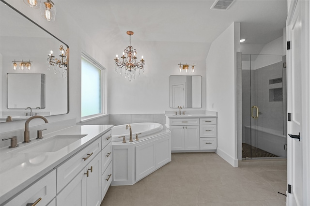 bathroom with an inviting chandelier, tile patterned flooring, independent shower and bath, and vanity