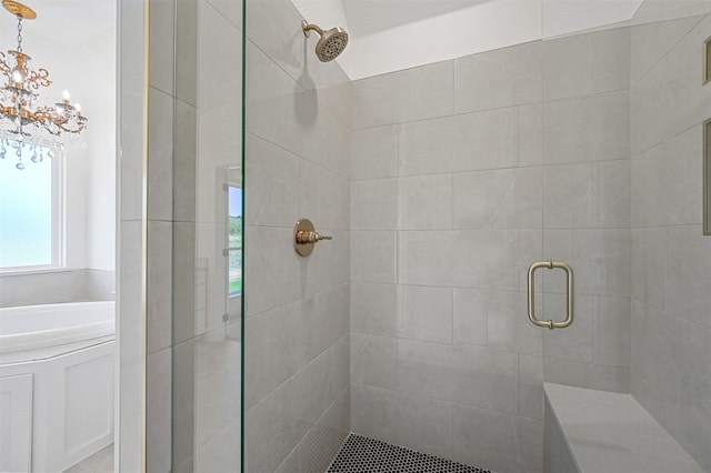 bathroom featuring a chandelier and a shower with door