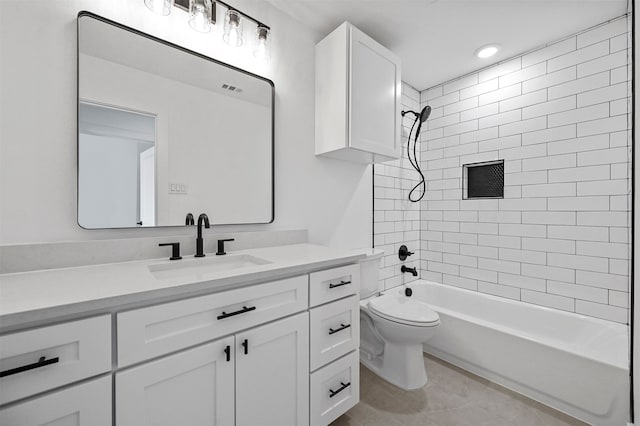 full bathroom featuring tile patterned floors, tiled shower / bath combo, vanity, and toilet