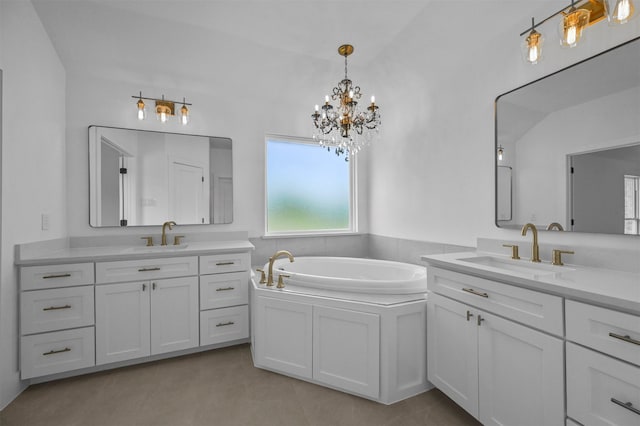 bathroom with an inviting chandelier, vanity, lofted ceiling, and a bathtub