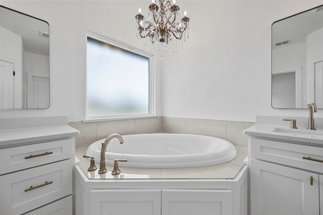 bathroom with a tub to relax in, vanity, and a chandelier