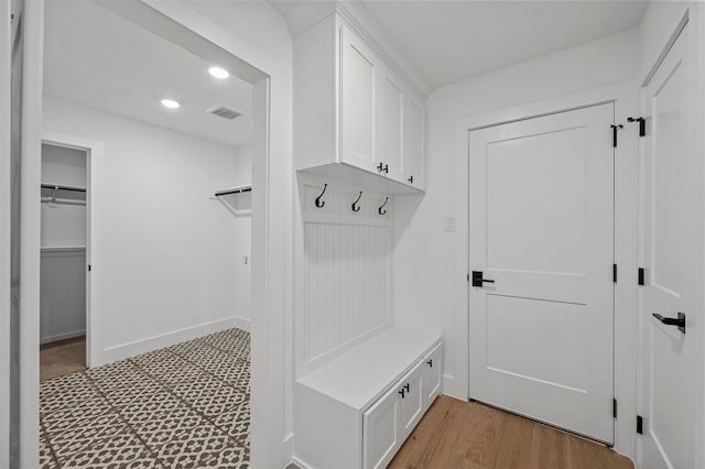 mudroom with light hardwood / wood-style floors