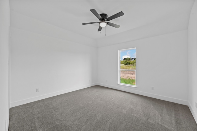 empty room featuring dark colored carpet and ceiling fan