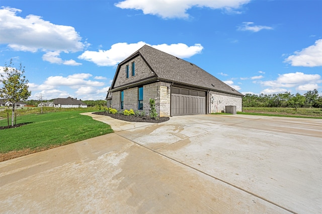 view of property exterior featuring a lawn and a garage