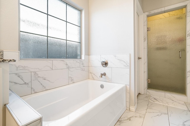 full bath with a shower stall, a garden tub, and marble finish floor