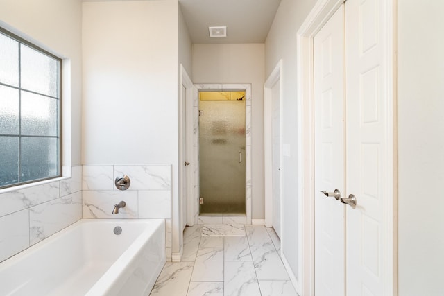 full bathroom with a bath, marble finish floor, visible vents, and a stall shower