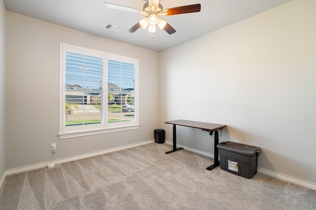 carpeted empty room with visible vents, ceiling fan, and baseboards
