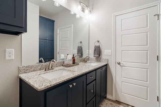 full bathroom with double vanity and a sink