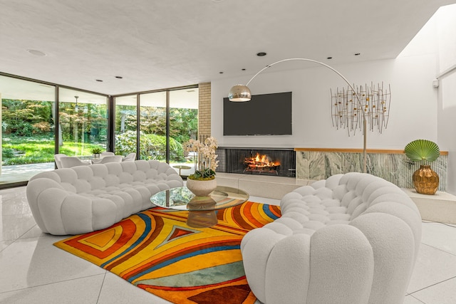 living room with floor to ceiling windows, a tile fireplace, and plenty of natural light