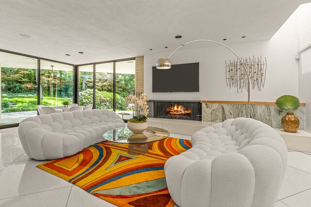 living room with floor to ceiling windows, a lit fireplace, and recessed lighting