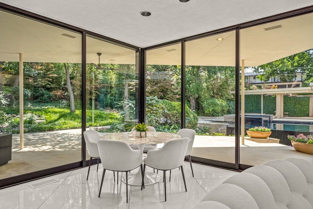 sunroom featuring a wall of windows