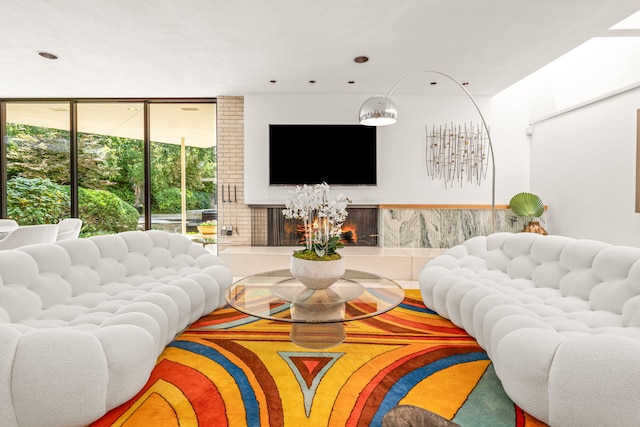 living room with a tiled fireplace and a healthy amount of sunlight