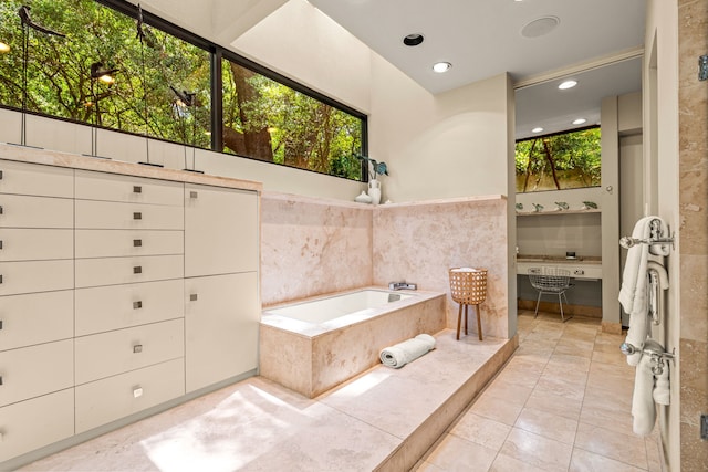 bathroom featuring tiled bath and tile patterned floors