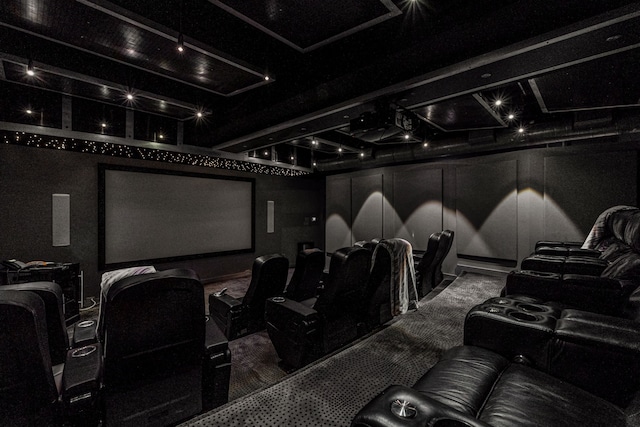 home theater room featuring a decorative wall and carpet flooring