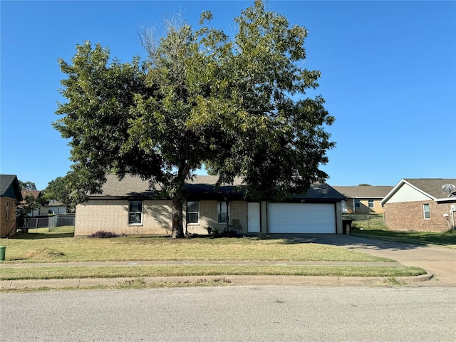 view of front of house featuring a front yard and a garage