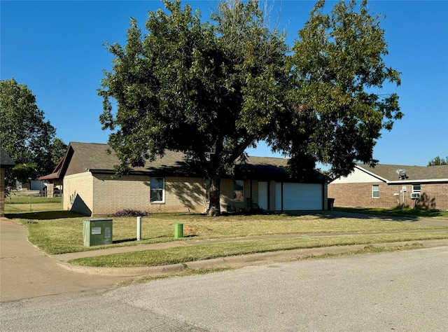 view of front facade with a front yard and a garage