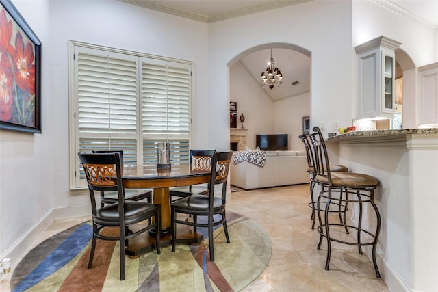 tiled dining space featuring a notable chandelier and crown molding