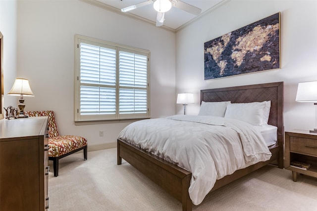 carpeted bedroom featuring crown molding and ceiling fan