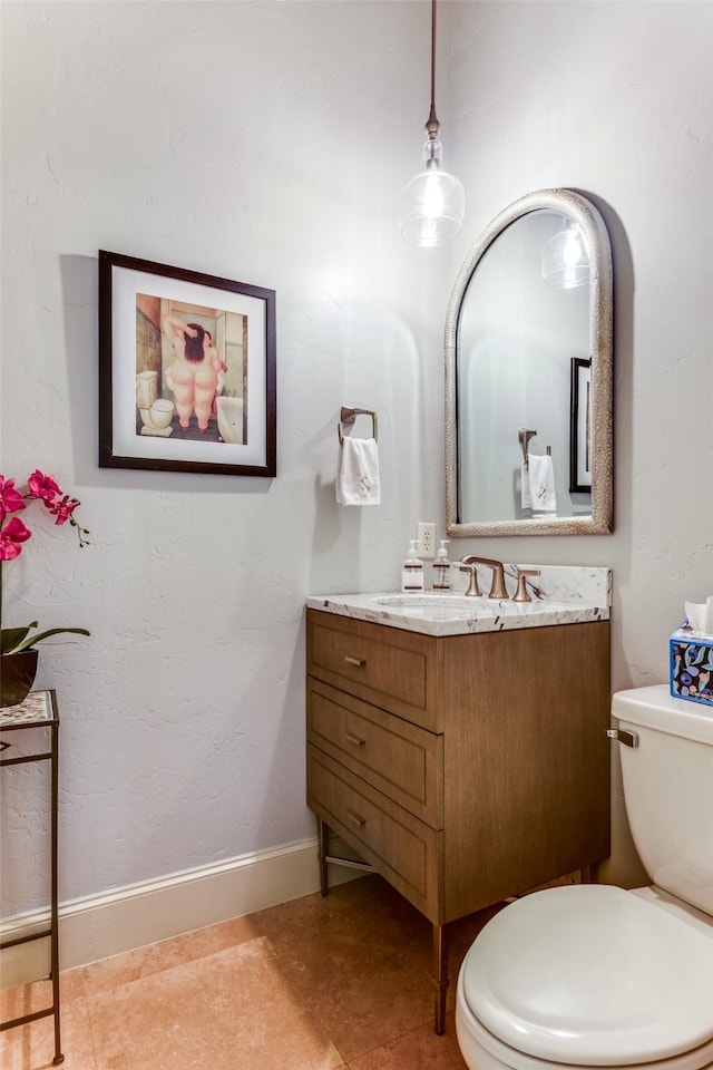 bathroom featuring vanity, tile patterned floors, and toilet