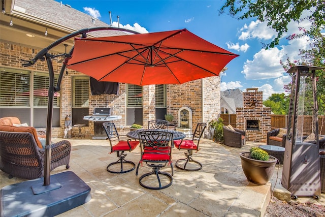 view of patio featuring an outdoor brick fireplace