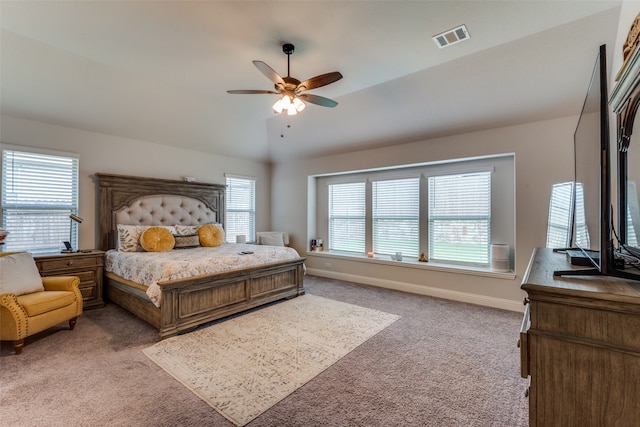 carpeted bedroom featuring vaulted ceiling, multiple windows, and ceiling fan