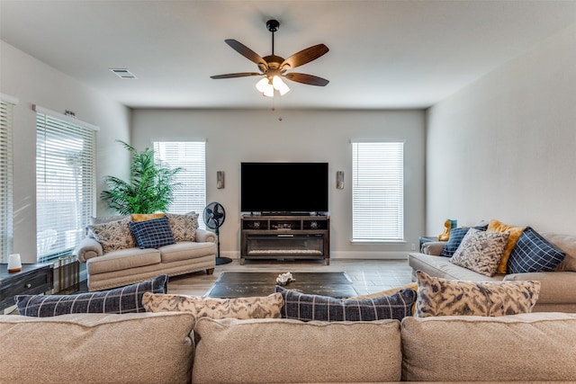 living room with ceiling fan, plenty of natural light, and light hardwood / wood-style floors