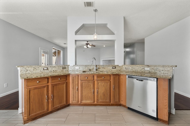 kitchen featuring a textured ceiling, ceiling fan, decorative light fixtures, stainless steel dishwasher, and sink