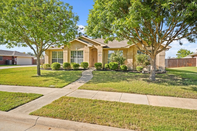 ranch-style house with a garage and a front lawn