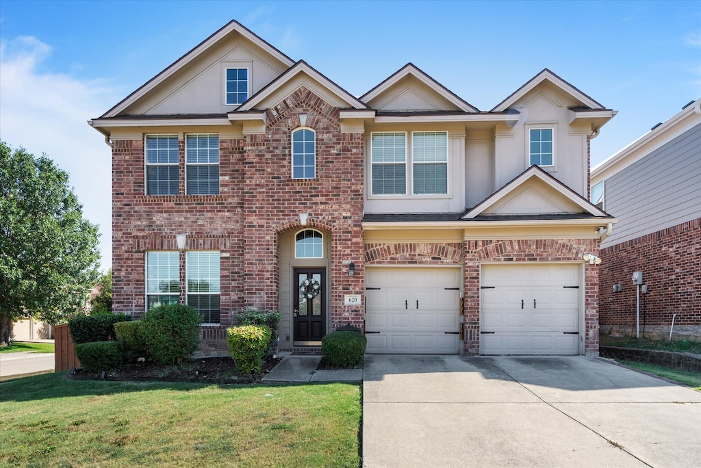 view of front facade with a front yard and a garage