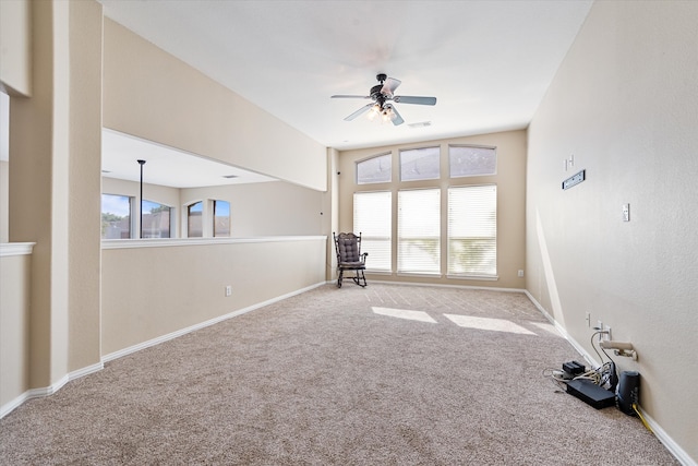 spare room featuring ceiling fan and light colored carpet