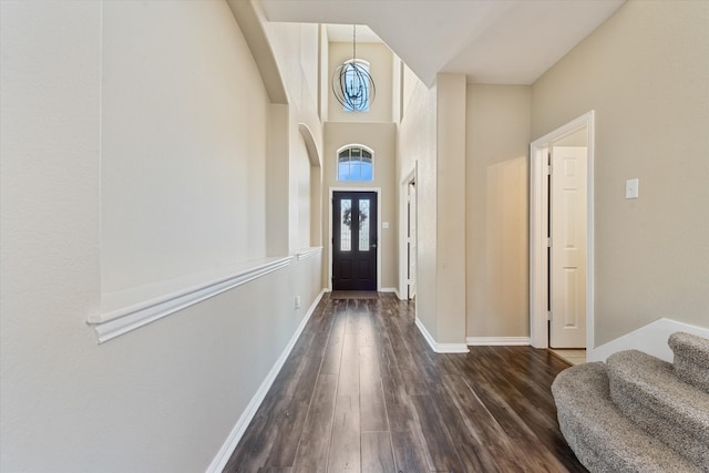 entrance foyer featuring a towering ceiling and dark hardwood / wood-style floors