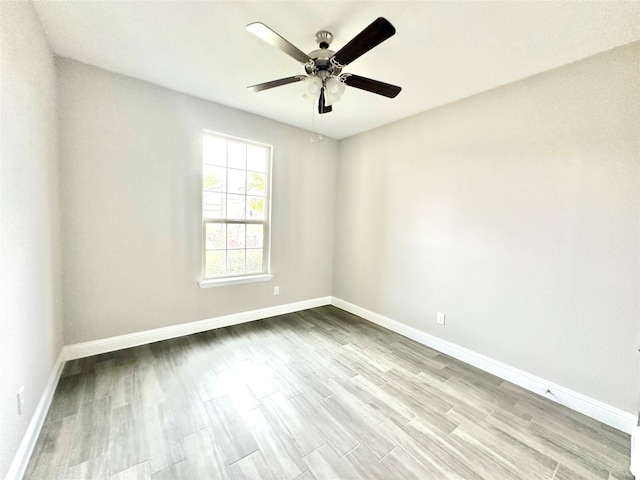 empty room featuring ceiling fan and light hardwood / wood-style flooring