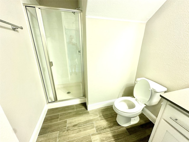 bathroom featuring an enclosed shower, hardwood / wood-style flooring, vanity, and toilet