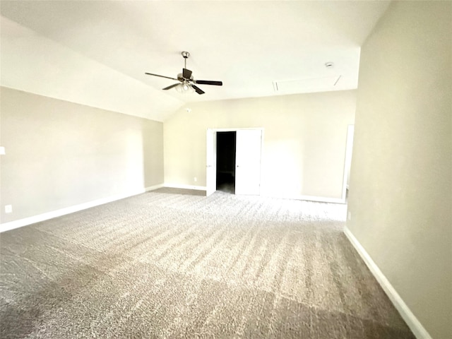 carpeted spare room with lofted ceiling and ceiling fan