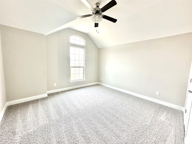 carpeted empty room featuring ceiling fan and lofted ceiling