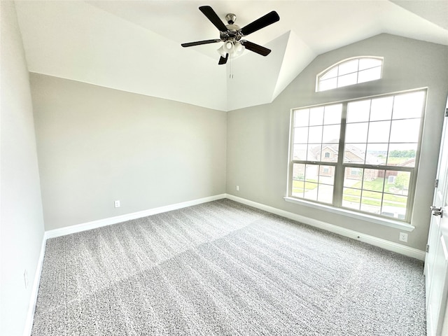 carpeted empty room with ceiling fan and vaulted ceiling