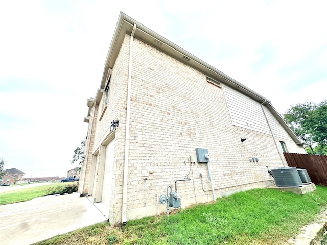 view of side of property with cooling unit and a garage